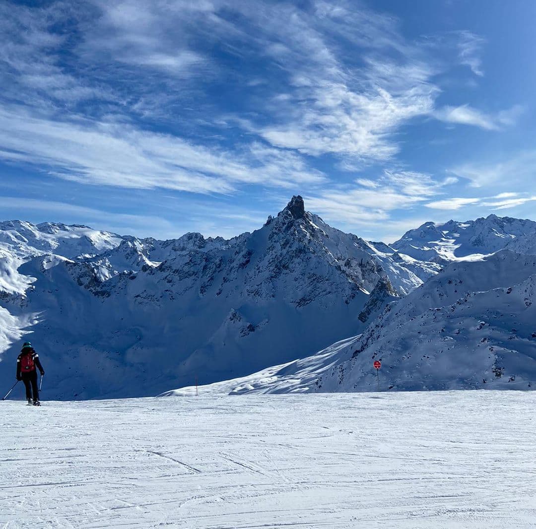 The French Alps, mountains covered in white snow and a blue cloudy sky